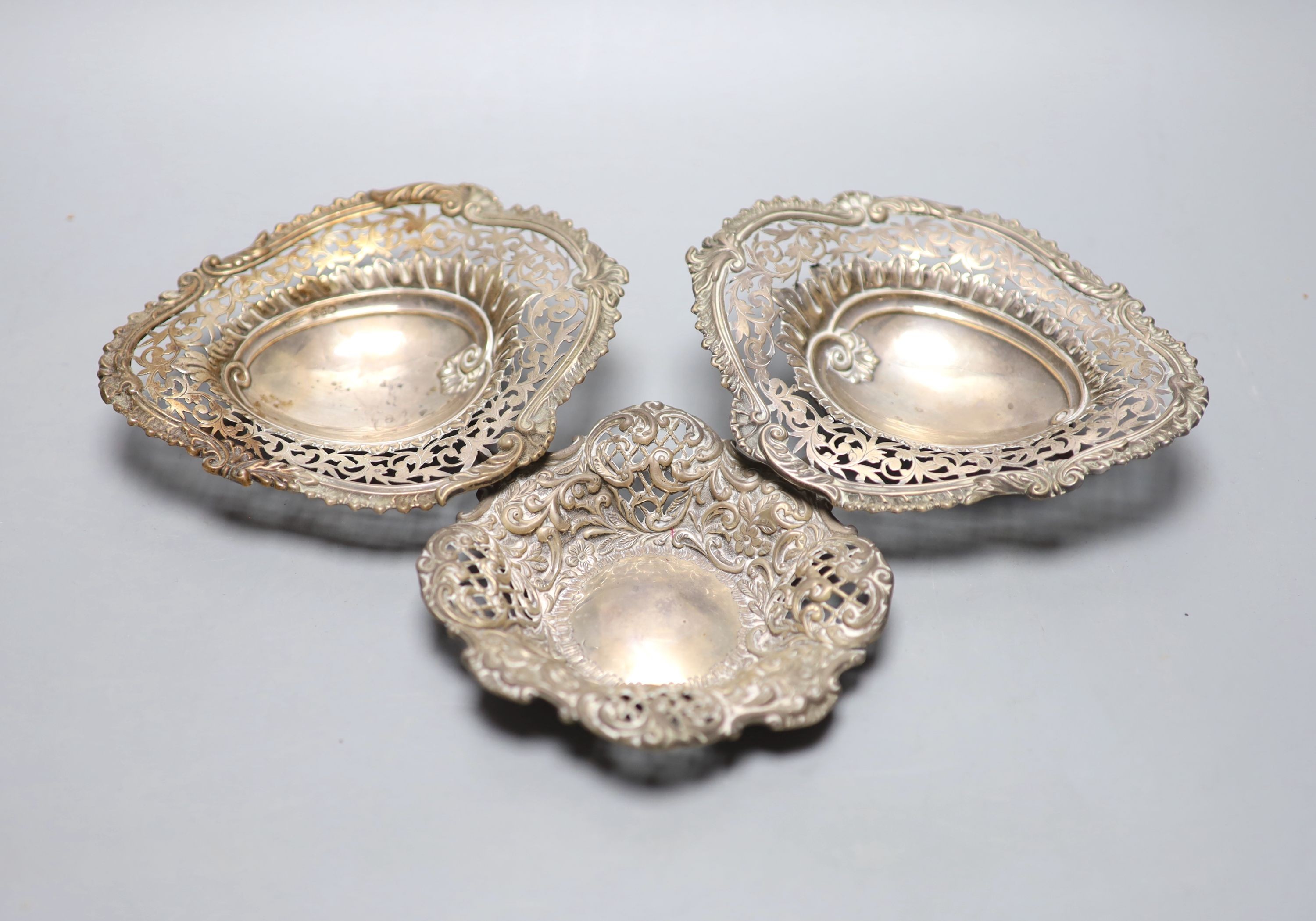 A pair of late Victorian silver shaped oval bonbon dishes, Birmingham, 1894, 13.9cm and one other pierced silver bonbon dish.